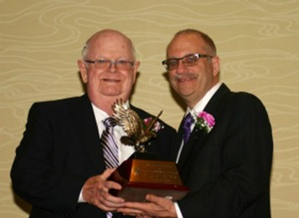 James Glynn, ’57, owner of the Maid of the Mist Corporation, receives the award for Family Business of the Year from Dr. Shawn Daly, dean of NU's College of Business Administration.