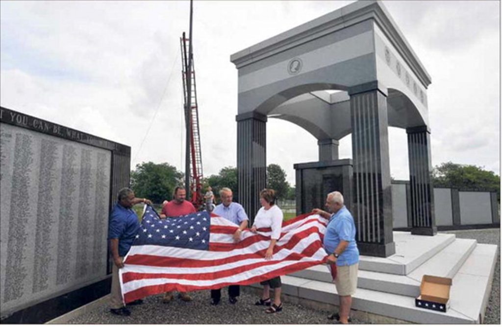 Niagara Falls veteran Ken Hamilton, Niagara Falls Veterans Commission director David Venditti, Jonathan Schultz, of the Maid of the Mist Corp., Jennifer Cooper, of Old Glory Flag Co., and David Fabrizio, one of the memorial commission’s founding members.